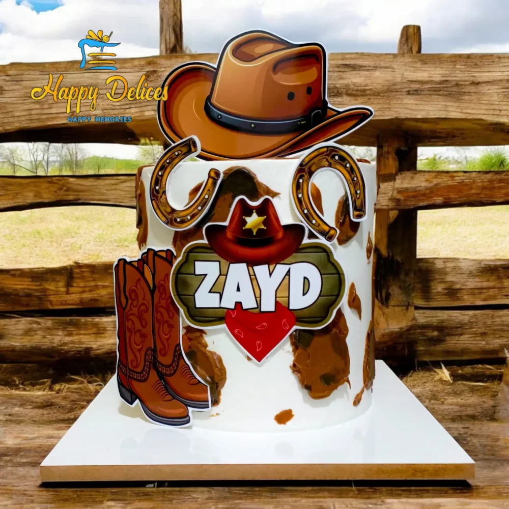Cowboy-themed birthday cake with hat, boots, and horseshoe decorations
