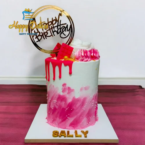 Pink and white drip birthday cake with golden accents and modern design