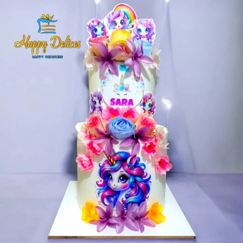 Two-tier unicorn birthday cake decorated with colorful flowers and cartoon characters