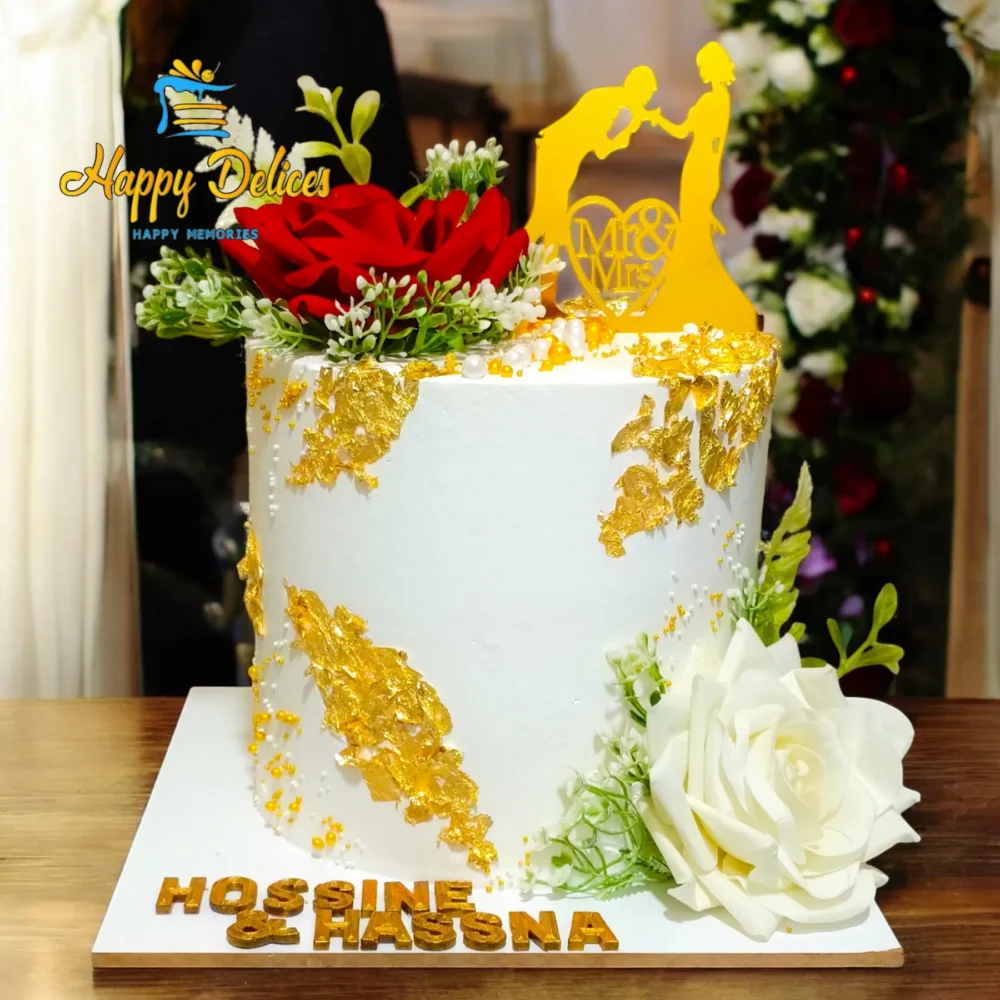 Elegant white engagement cake with gold accents and red flowers