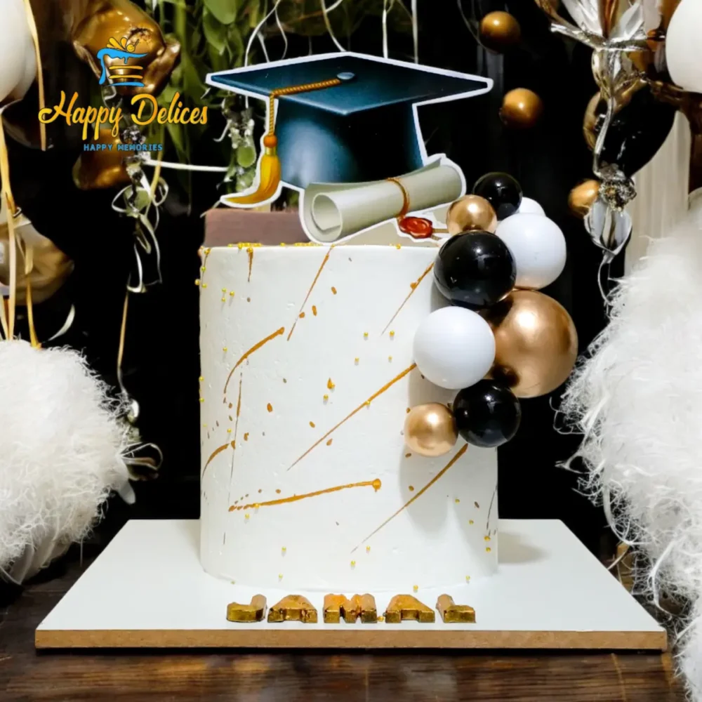 Minimalist graduation cake with gold and black details, diploma scroll, and balloon decorations
