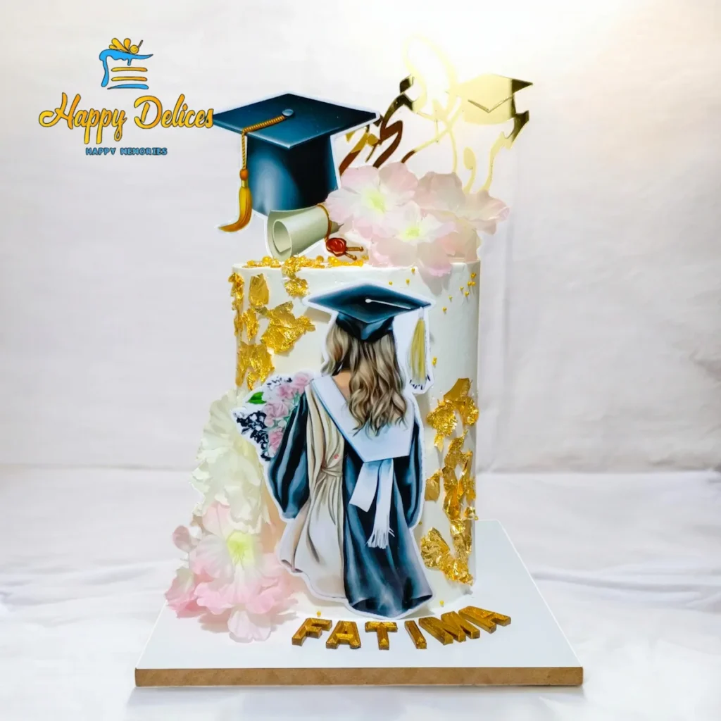 Elegant graduation cake with golden details, flowers, and graduation cap topper