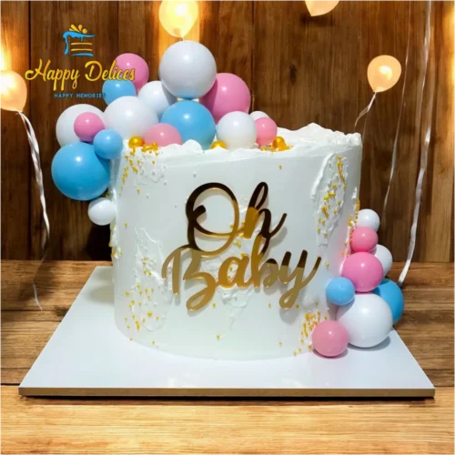 Oh Baby gender reveal cake with pink and blue balloon decorations