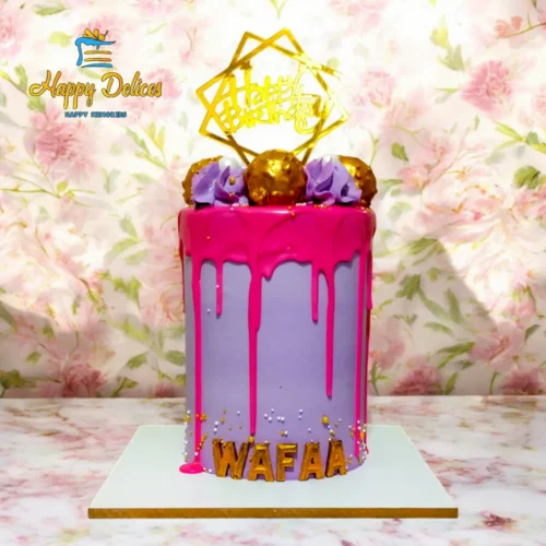 Elegant pink and purple women’s birthday cake with gold decorations and drip design