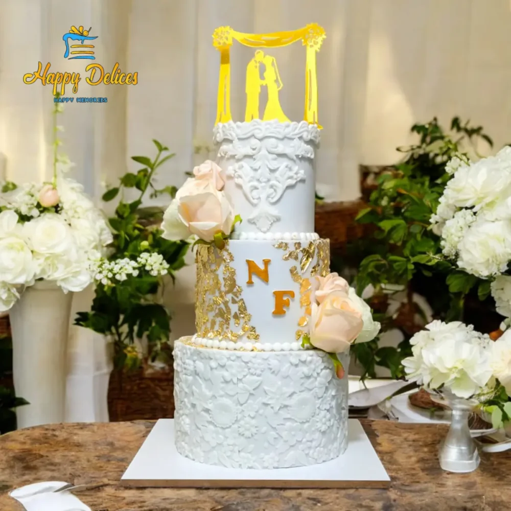 Elegant white and gold wedding cake with floral details
