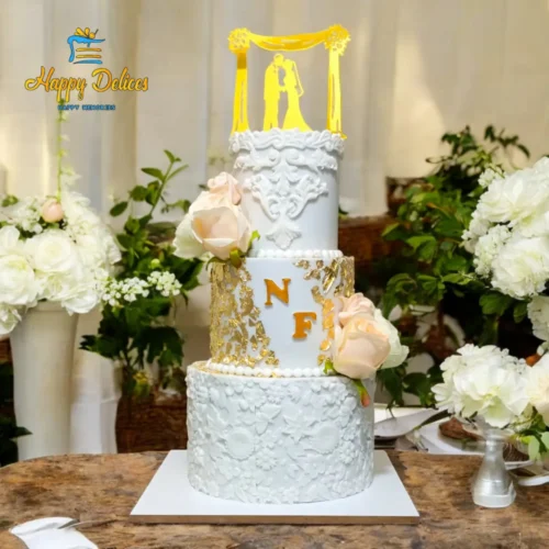 Elegant White & Gold Wedding Cake Happy Delices Elegant white and gold wedding cake with floral details