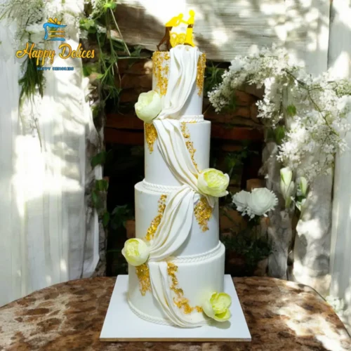 Elegant White Wedding Cake with Drapes - Happy Delices Three-tier elegant white wedding cake with gold leaf and flowing drapes