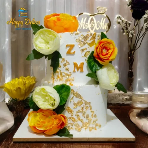 Two-Tier White & Gold Floral Engagement Cake | Happy Delices Two-tier engagement cake with gold textured accents and yellow, orange, and white flowers by Happy Delices