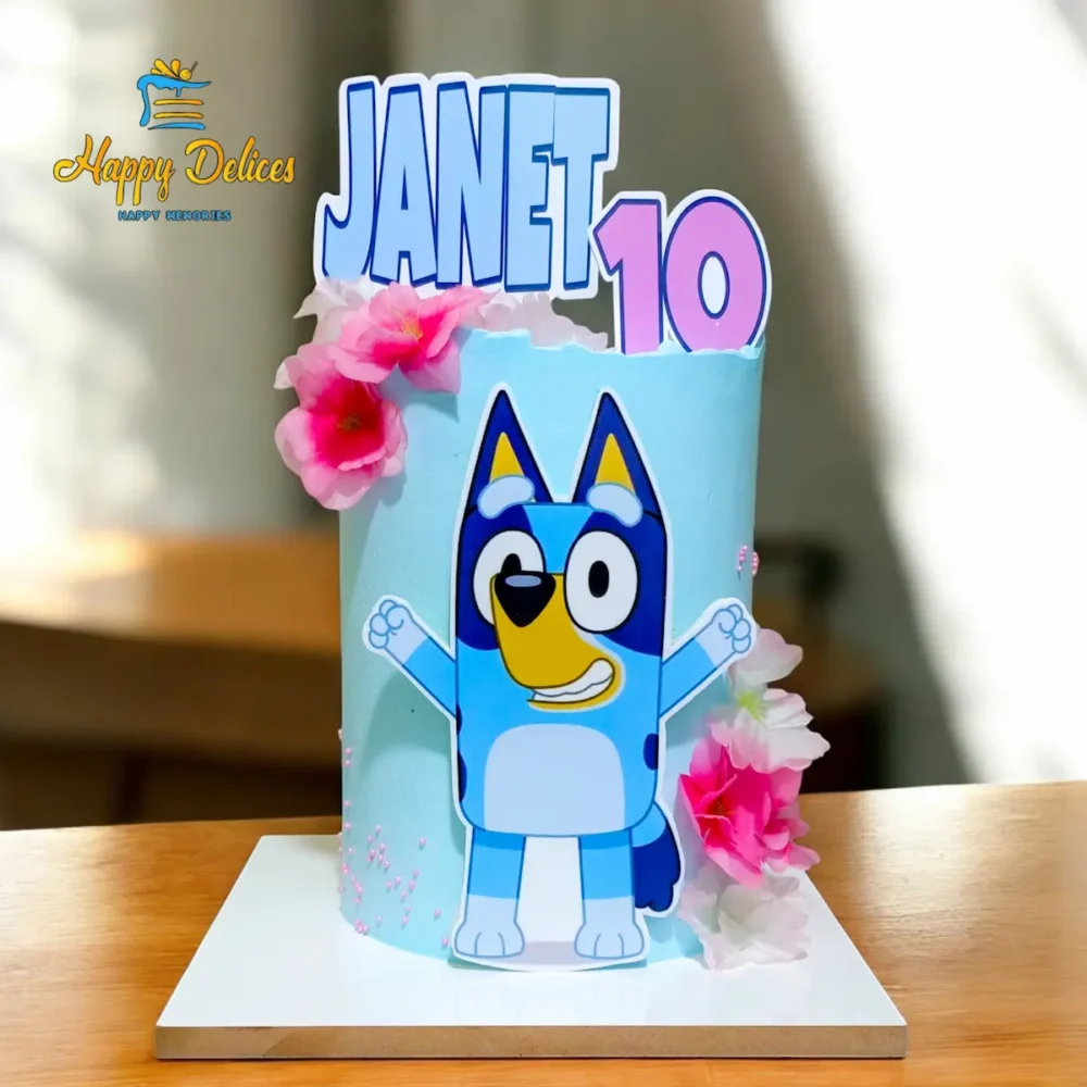 Bluey themed birthday cake with pink flowers by Happy Delices