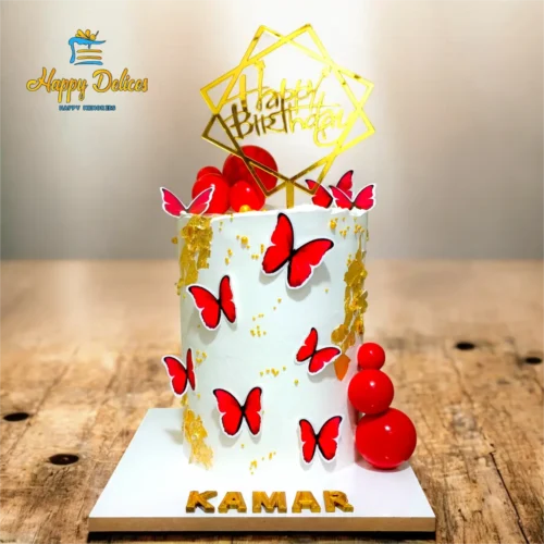 Elegant white birthday cake with red butterflies and gold leaf by Happy Delices