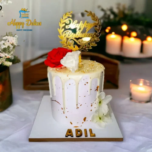 Elegant white and gold birthday cake with floral decoration and drip design by Happy Delices