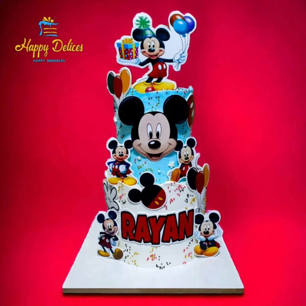 Two-tier Mickey Mouse birthday cake with colorful decorations and character cutouts by Happy Delices