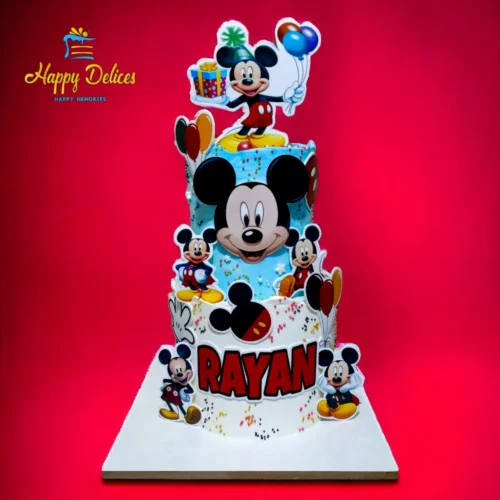 Two-tier Mickey Mouse birthday cake with colorful decorations and character cutouts by Happy Delices
