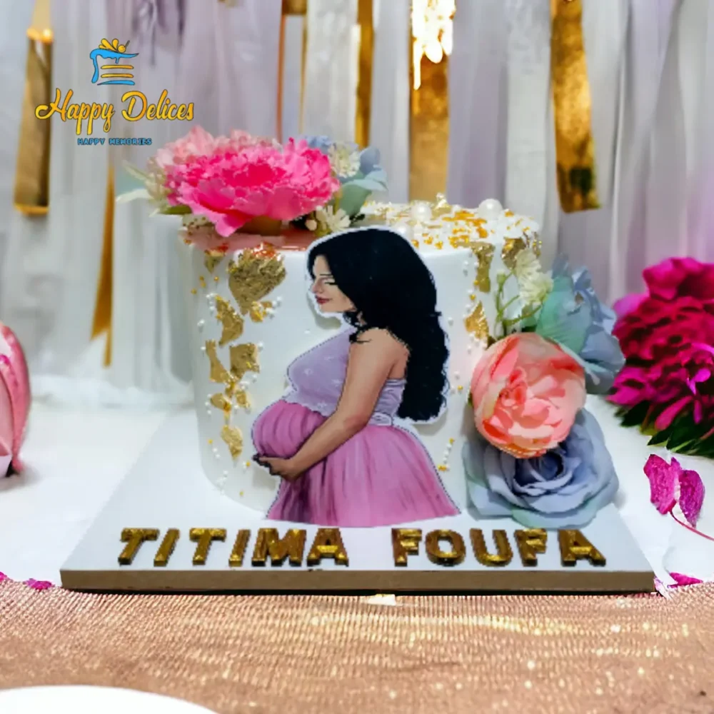 Elegant maternity themed cake with floral decorations and gold accents by Happy Delices