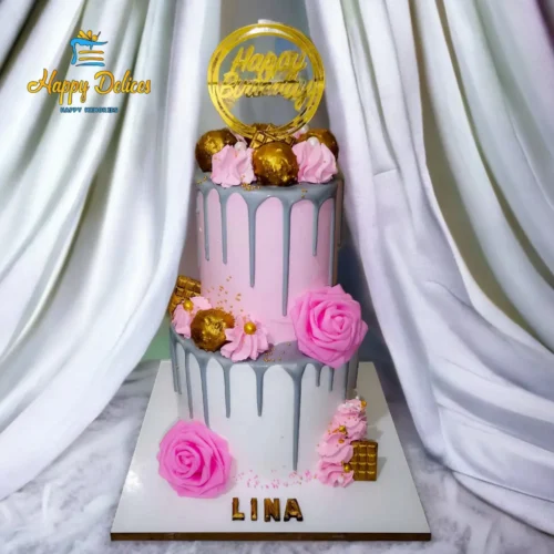 Elegant two tier birthday cake in pink and grey with gold details by Happy Delices