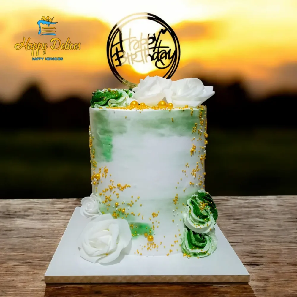 Elegant green and white birthday cake with gold sprinkles, floral decorations and Happy Birthday topper by Happy Delices