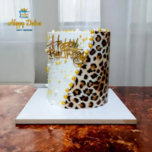 Leopard print and white luxury birthday cake with gold pearls and Happy Birthday topper by Happy Delices
