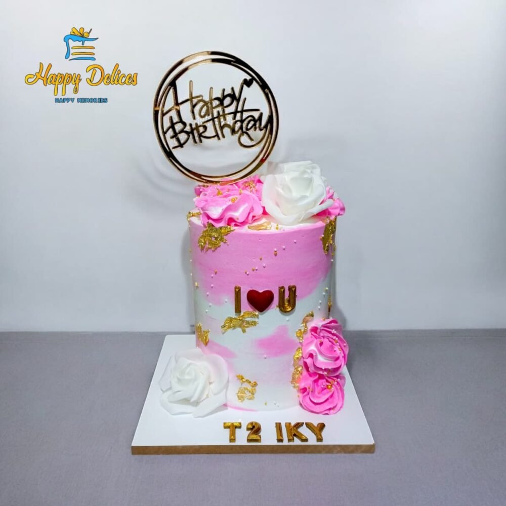 Pink and white ombre birthday cake with gold accents, roses, and Happy Birthday topper by Happy Delices