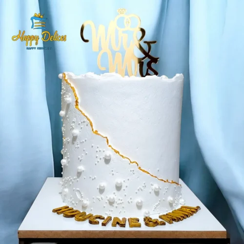 Elegant white wedding cake with gold details and Mr and Mrs topper by Happy Delices
