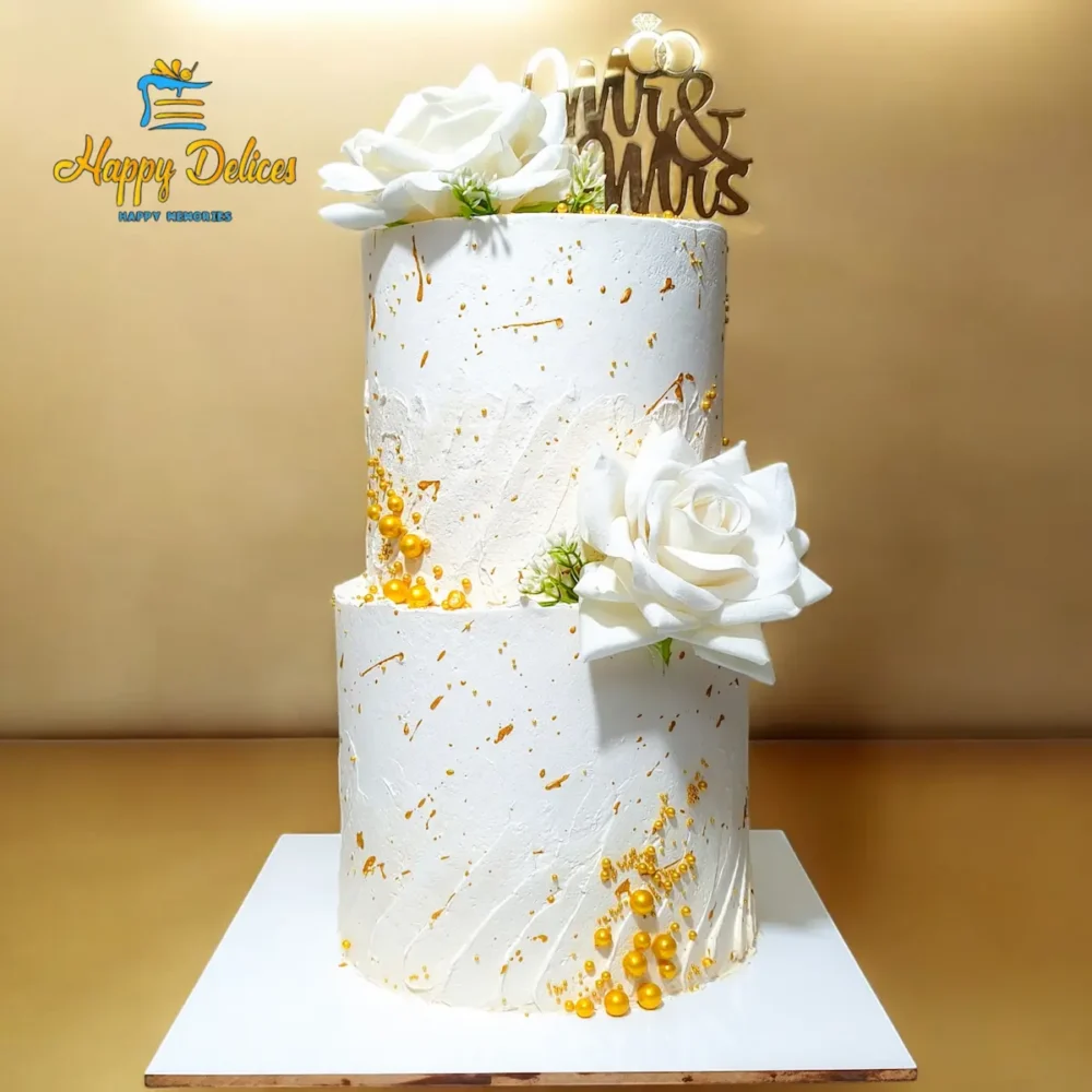 Elegant white and gold wedding cake with Mr and Mrs topper and roses by Happy Delices