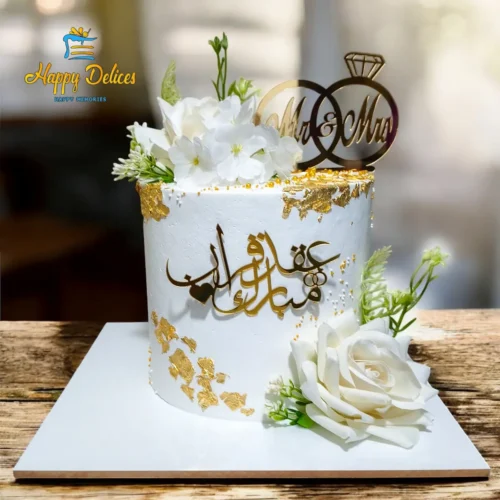 Elegant Arabic engagement cake with white flowers and gold details by Happy Delices