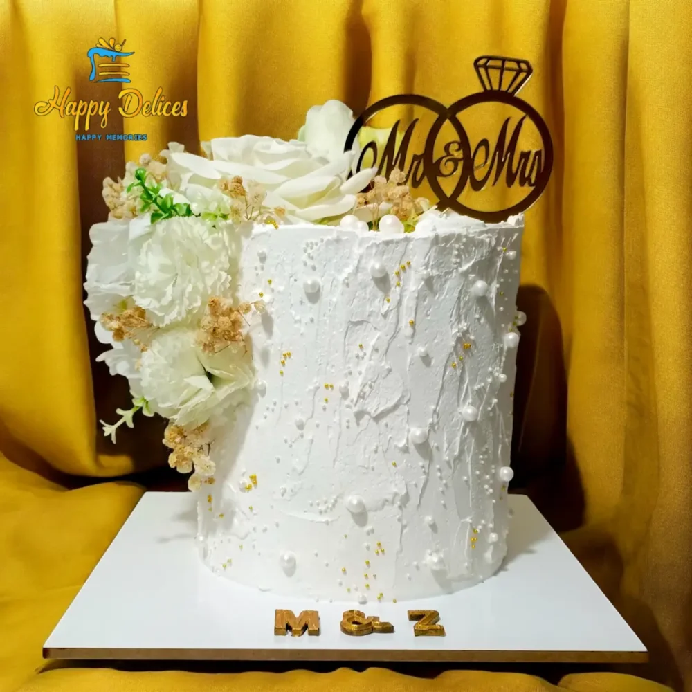 Luxury White Floral Engagement Cake with Elegant Texture | Happy Delices Elegant white engagement cake with floral decorations and textured finish by Happy Delices