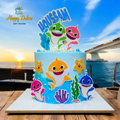 Baby Shark Birthday Cake | Happy Delices Baby Shark themed birthday cake with colorful ocean decorations and personalized Youssam topper by Happy Delices.
