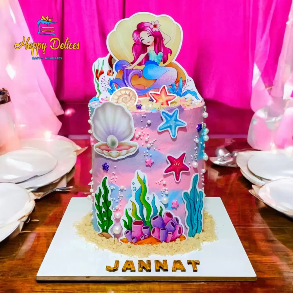 Mermaid Birthday Cake | Happy Delices Agadir Pastel pink and purple mermaid birthday cake for Jannat, decorated with seashells, starfish, coral, pearls and a mermaid topper by Happy Delices Agadir.